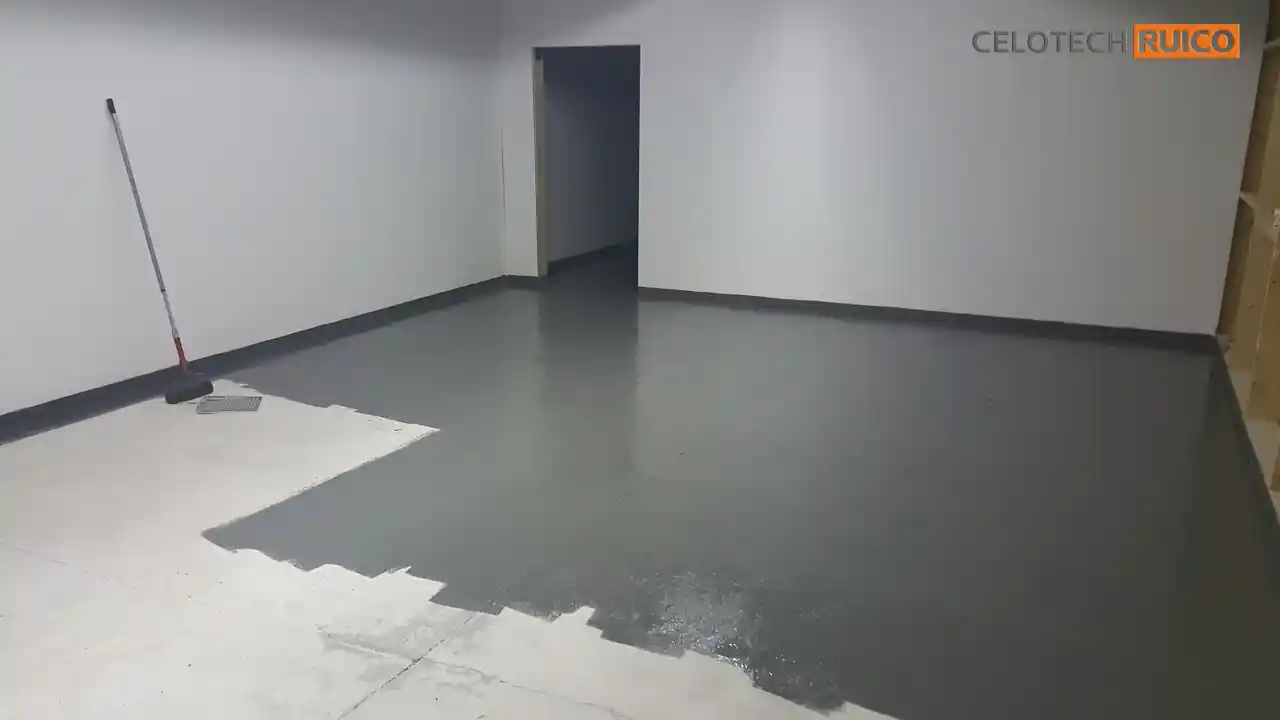 Applying epoxy floor coating in the workshop